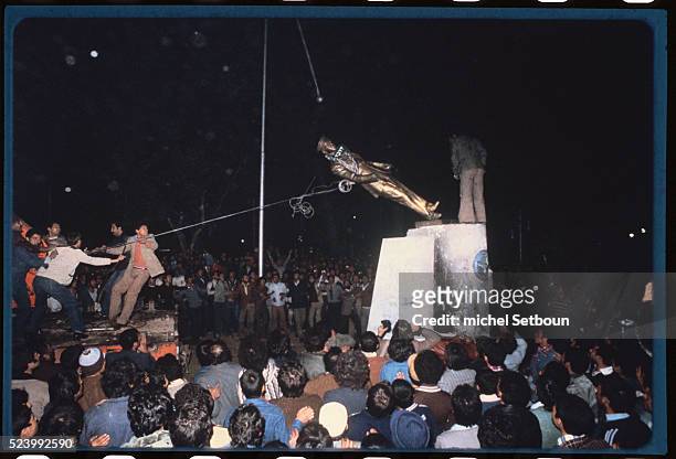 Statue is torn by anti-Shah demonstrators.