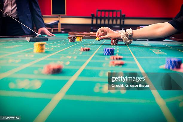 gamblers playing roulette in a casinoi - gambling chip stock pictures, royalty-free photos & images