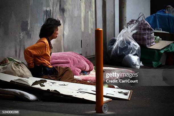 Homeless woman sits in the street in the slum area of Kamagasaki on April 23, 2016 in Osaka, Japan. Kamagasaki, a district in Japan's second largest...