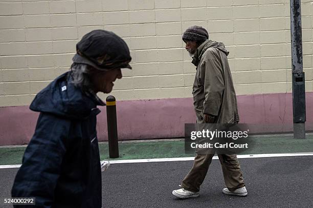 Homeless men walk along a street in the slum area of Kamagasaki on April 23, 2016 in Osaka, Japan. Kamagasaki, a district in Japan's second largest...