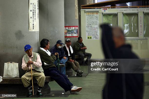 Homeless men wait around in the slum area of Kamagasaki on April 23, 2016 in Osaka, Japan. Kamagasaki, a district in Japan's second largest city...