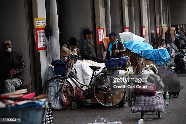 Homeless men wait around in the slum area of Kamagasaki on April 23, 2016 in Osaka, Japan. Kamagasaki, a district in Japan's second largest city...