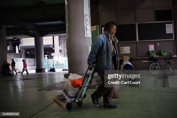 Man pulls his belongings through the slum area of Kamagasaki on April 23, 2016 in Osaka, Japan. Kamagasaki, a district in Japan's second largest city...