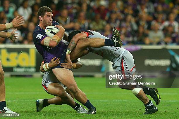 Kenneath Bromwich of the Storm is tackled during the round eight NRL match between the Melbourne Storm and the New Zealand Warriors at AAMI Park on...