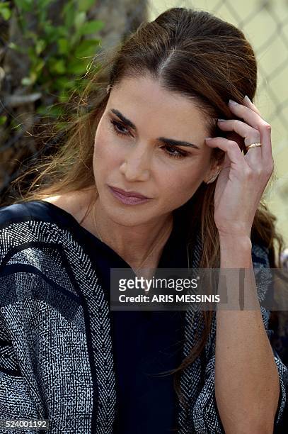 Queen Rania of Jordan during her visit at the refugee site of Kara Tepe in Mytilene on April 25, 2016. / AFP / ARIS MESSINIS