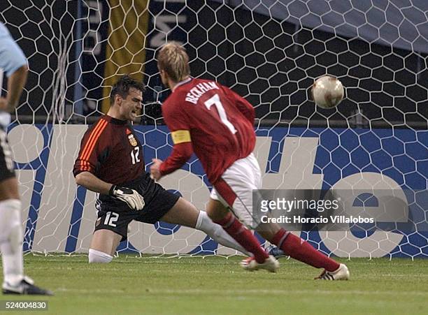 English National Soccer team captain David Beckham scores a penalty kick against Argentine goalie Pablo Cavallero in their 2002 World Cup game....