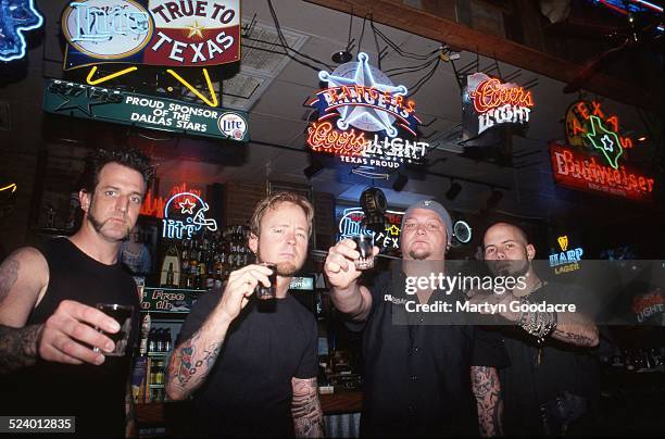 Drowning Pool drink shots in a bar in Dallas, Texas, United States, 2002. The line up contains Dave Williams, CJ Pierce, Steve Benton and Mike Luce.