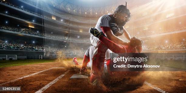 sliding and tagging on base - baseball catcher 個照片及圖片檔