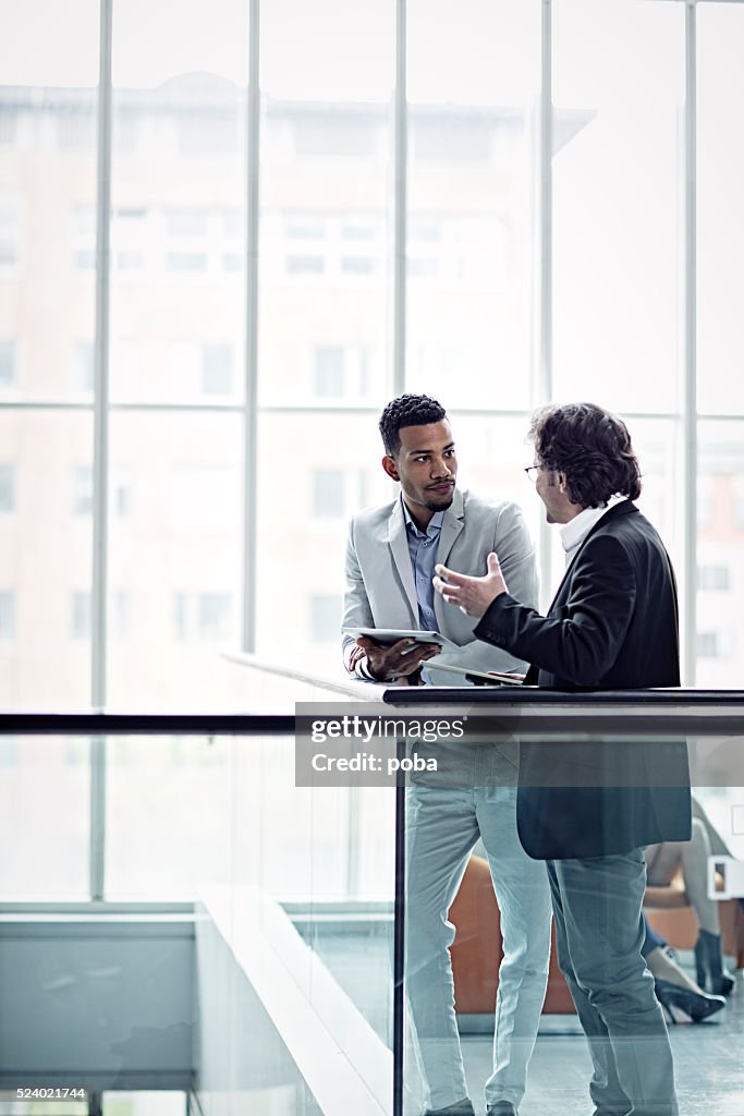 Two busuinessmen having a casual talk in hall