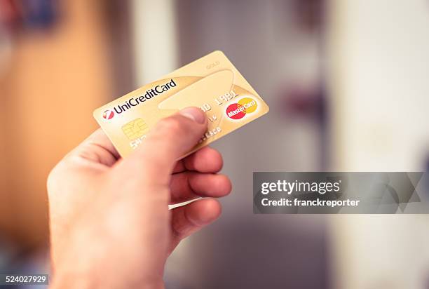paying with credit card - unicredit bank stockfoto's en -beelden