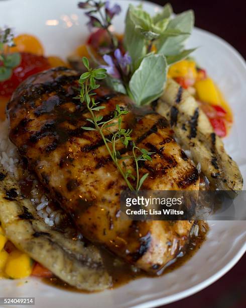 Spicy Jamaican Chicken. Wood grilled boneless breast of chicken marinated in a hot and spicy Jamaican Jerk Sauce, served over lemon thyme rice with...