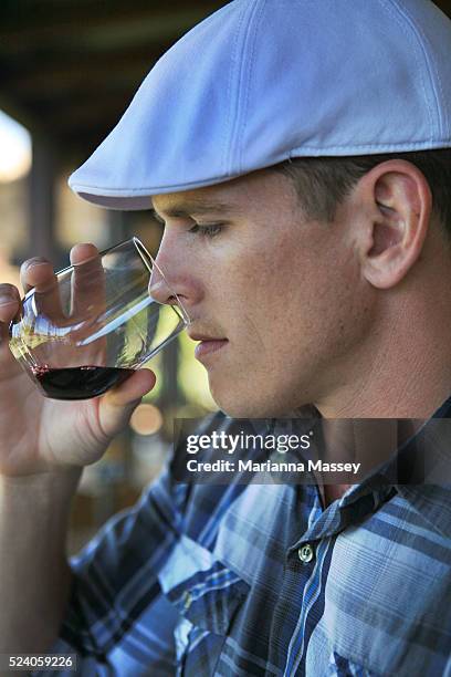 Young man wine tasting at Laurance winery in the Margaret River Wine Region. Margaret River is a town and river in the South West of Western...