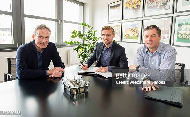 Marcel Schmelzer of Borussia Dortmund with Hans-Joachim Watzke and Michael Zorc as he renews Contract Until 2021 for Borussia Dortmund on April 25,...