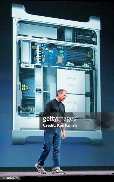 Apple CEO Steve Jobs stand in front of a picture of the inside of the Apple Power Mac G5 personal computer, while introducing it to the world at the...