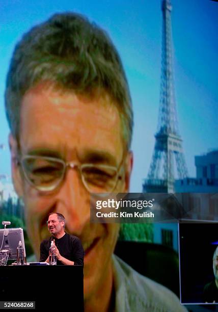Apple CEO Steve Jobs sits at his computer during a live video conference with Jean-Marie Hullot at his home in Paris, France, during his keynote...