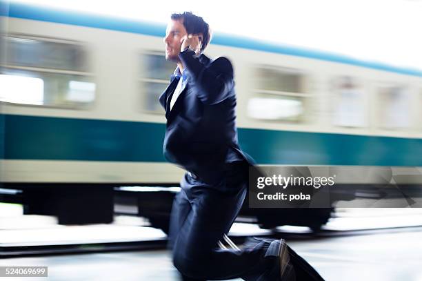 businessman  with roller case running for train on station platform - chasing stock pictures, royalty-free photos & images