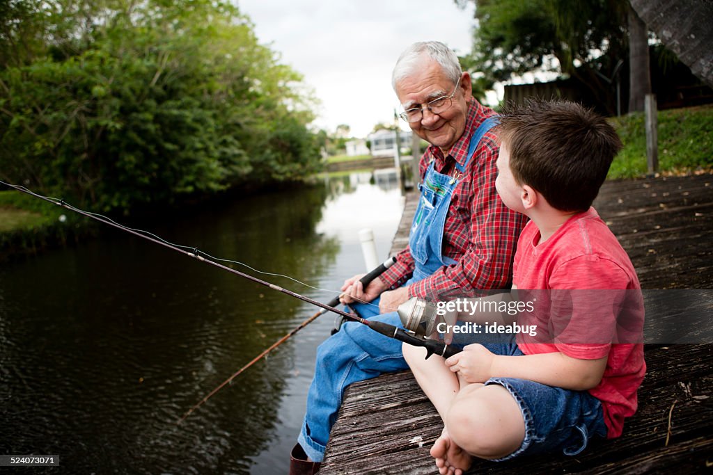 Happy Grandfather and Great Grandson Fishing Together