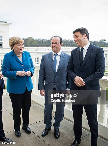 German Chancellor Angela Merkel greets France's President Francois Hollande, and Prime Minister of Italy Matteo Renzi at Schloss Herrenhausen palace...