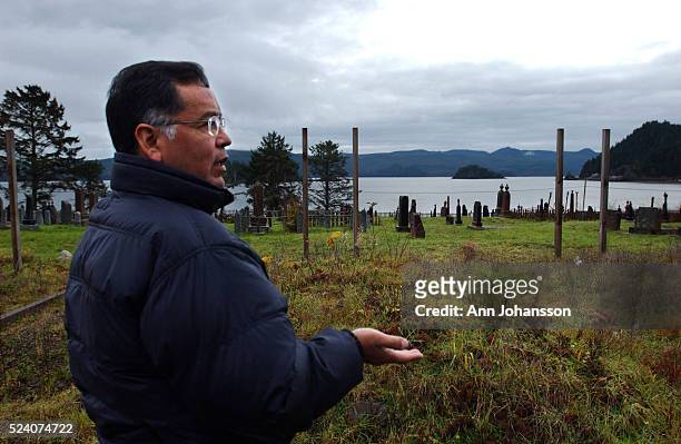 Andy Wilson, co-founder of the Haida repatriation committee, stands by mass graves where repatriated remains are buried, in the Skidegate Cemetery in...