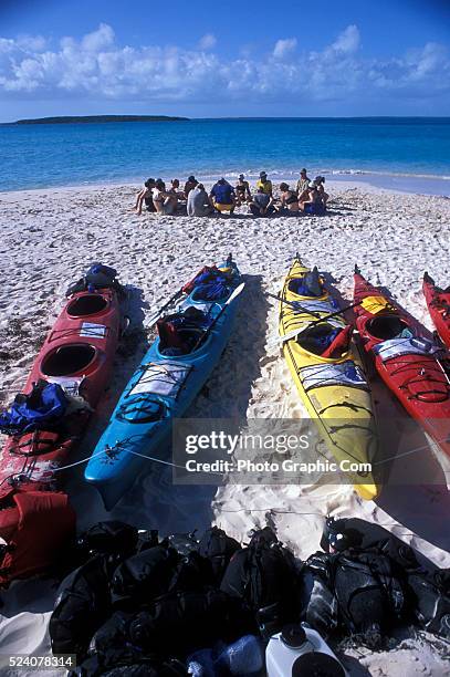 An Outward Bound adult expedition ages 26 and over prepare to depart a small island on an 8 day sea kayaking course in the Exuma Islands of the...