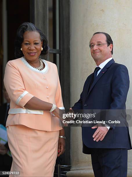 French President Francois Hollande, left, welcomes interim Central African Republic President Catherine Samba-Panza, as they pose for photographers...