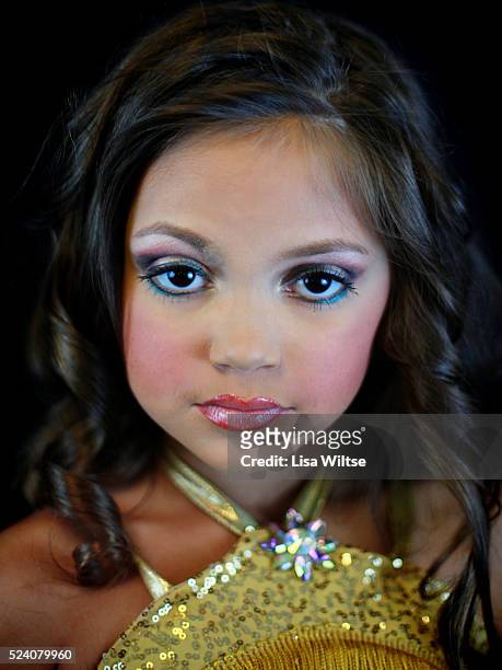 Age 8, posing for a portrait during the Angel Face Nationals in Liverpool, New York on October 27, 2012. Photo by Lisa Wiltse