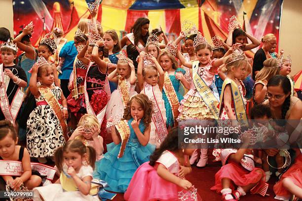 Young contestants gathering on stage for a group portrait after crowning during the Big Top Pageant in Harrisburg, Pennsylvania on August 12, 2012....
