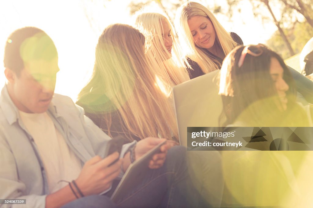 Group of young people with mobile devices.