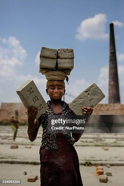 Lubna is a 13 year old girl who is lifting bricks on her head, in Dhaka, Bangladesh, on April 25, 2016. She earns 2, in Dhaka, Bangladesh, on April...