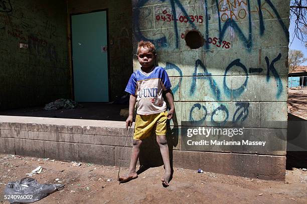 Daily life in one of the many Aboriginal town camps on the outskirts of Alice Springs in the Northern Territory. A young Aboriginal boy outside of...