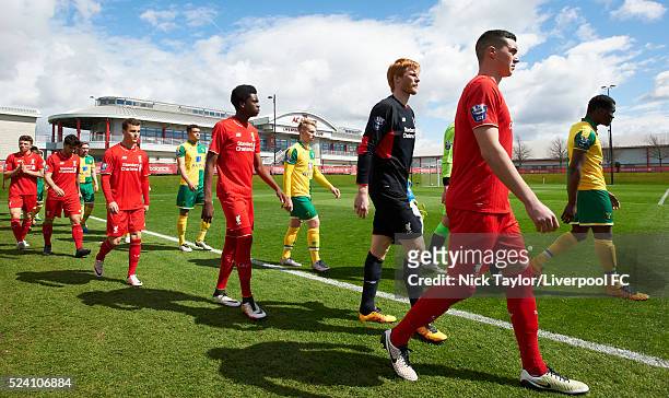 Lloyd Jones of Liverpool, and Michee Efete of Norwich City lead their teams onto the pitch at the start of the Liverpool v Norwich City U21 Premier...