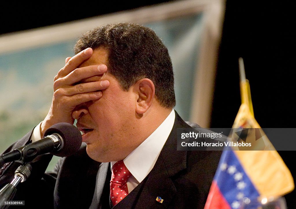 Hugo Ch Venezuelan President Hugo Chavez covers his face as part of one of ...