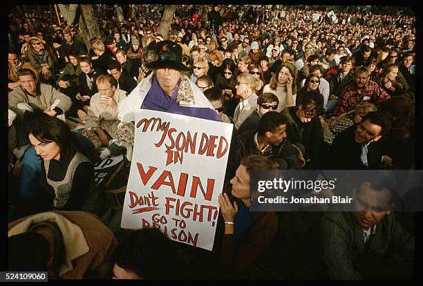 The mother of a man who dies in Vietnam holds up a sign protesting U.S. Involvement in the war during a demonstration.