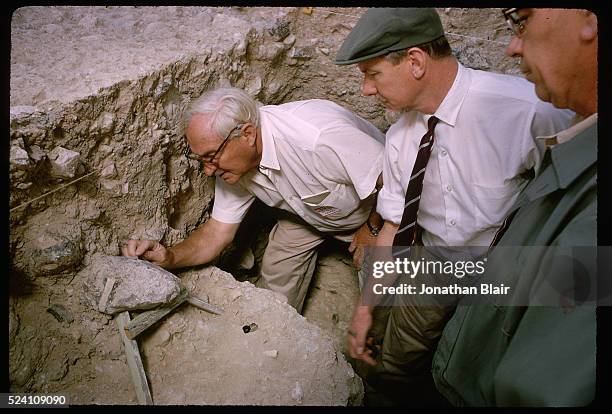 Visiting scientists gather around Dr. Louis Leakey to see the artifacts that have been recovered at the Calico Hills, Early Man, dig site in Yermo,...