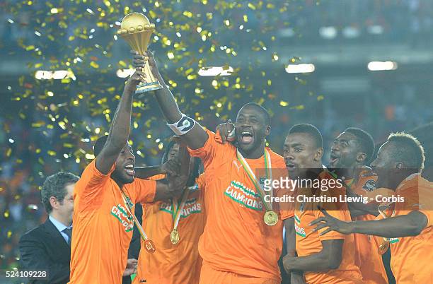 Ivory Coast's Yaya Toure holds up the trophy as he celebrates with his teammates after winning after the 2015 Orange Africa Cup of Nations Final...