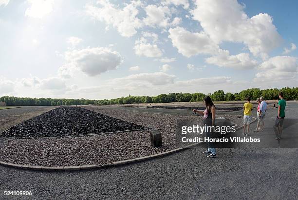Visitors by the memorial stone in Block 23 for the 27,000 female prisoners, in Buchenwald concentration camp near Weimar, Germany, 21 July 2013. The...
