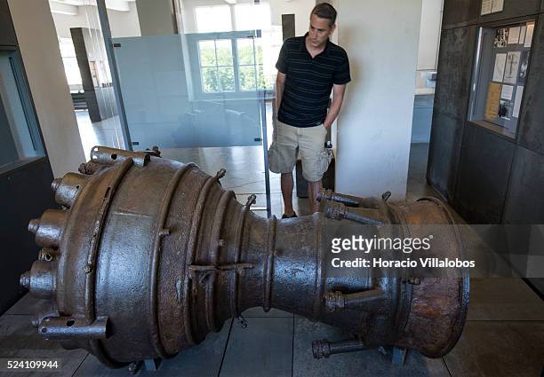 Visitor watches part of a V-2 bomb engine, made by slave workers in Mittelbau-Dora, at the camp exhibit in Buchenwald concentration camp near Weimar,...