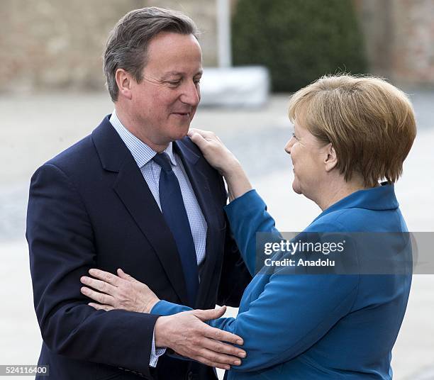 German Chancellor Angela Merkel welcomes British Prime Minister David Cameron before their meeting at Schloss Herrenhausen palace in Hanover, Germany...