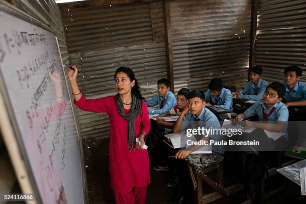 Teacher Jeni Raybhandari teaches math class in very basic temporary classrooms at the badly damaged Durbar High school one of Kathmandu's oldest...