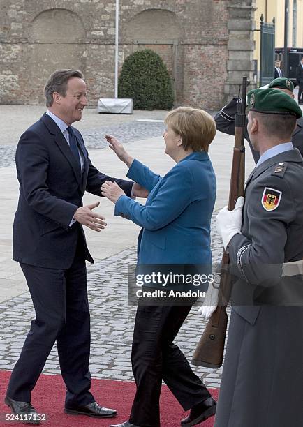 German Chancellor Angela Merkel welcomes British Prime Minister David Cameron before their meeting at Schloss Herrenhausen palace in Hanover, Germany...