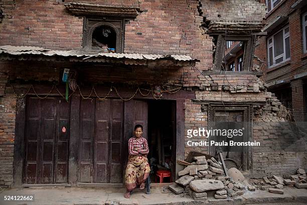 Woman sits in front of a damaged building on April 25, 2016 in Bhaktapur, Nepal. One year after the devastating earthquake, the government of Nepal...