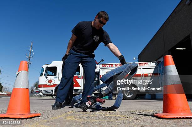 Engineer Joe Marsala drops hose during a drill at South Adams County Fire Station 3 in Commerce City, Colorado on April 21, 2016. The South Adams...