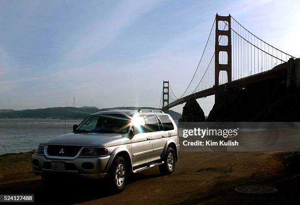 Mitsubishi Montero Sport SUV travels under the Marin County side of the Golden Gate Bridge. SUVs are popular with many Californians even as they are...