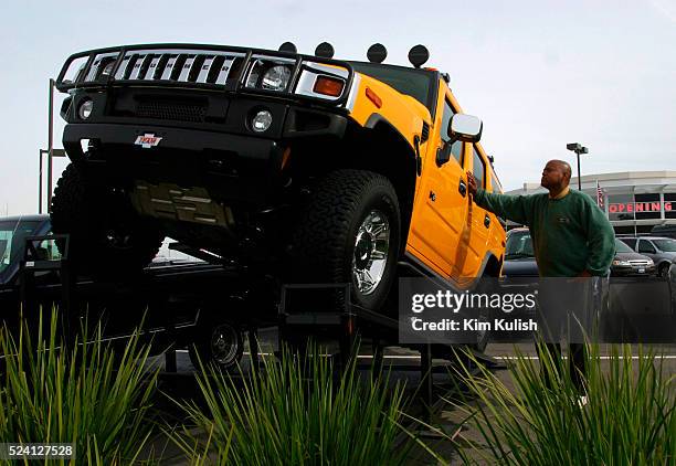 Hummer specialist Michael Jenkins examines a brand new 2003 Hummer H2 vehicle on the lot at Team Hummer of Marin. SUVs are popular with many...