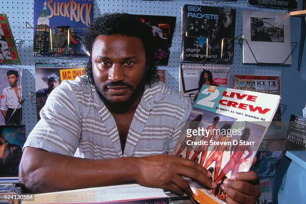 Charles Freeman holds a 2 Live Crew record sleeve depicting scantily clad women. Police arrested Freeman for selling this album in his record store.