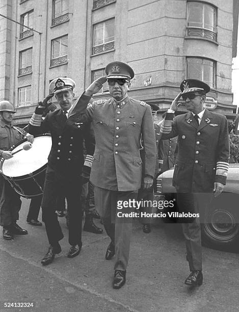 Admiral Toribio Merino, General Augusto Pinochet, and Air Force General Leigh salute while walking to join the Te Deum on September 18, Independence...