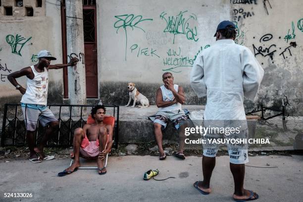 Popole Misenga a refugee judoka from the Democratic Republic of Congo, shows his judogi to neighbors with a sponsor's badge stitched on it near his...