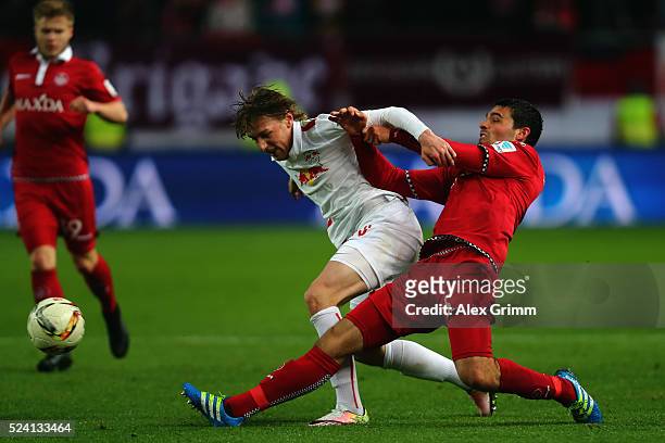 Emil Forsberg of Leipzig is challenged by Sascha Mockenhaupt of Kaiserslautern during the Second Bundesliga match between 1. FC Kaiserslautern and RB...