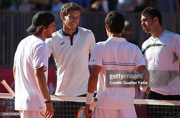 Pablo Carreno Busta from Spain and teammate Inigo Cervantes congratulates opponents Pedro Sousa and Rui Machado at the end of the doubles match...