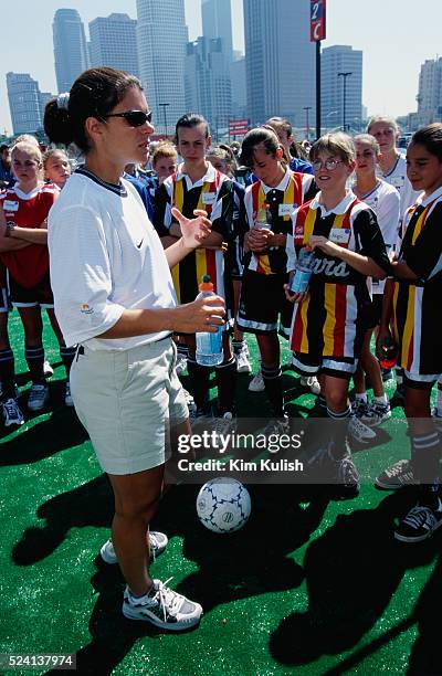 Soccer star Mia Hamm speaks with a group of girls at a soccer training clinic in Los Angeles, California.